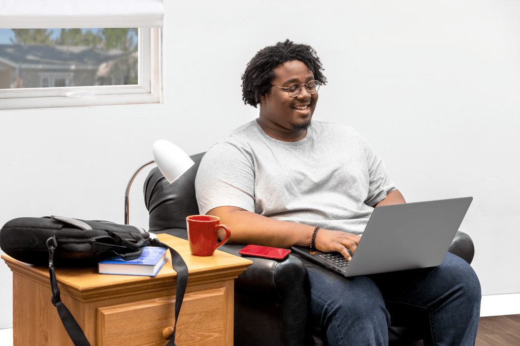 A college student studies for finals in his dorm room.