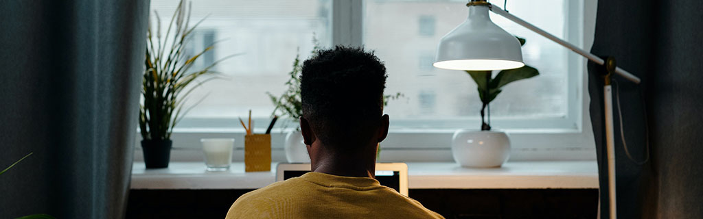 student studying underneath lamp