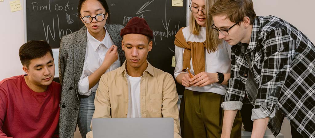 students looking at laptop together