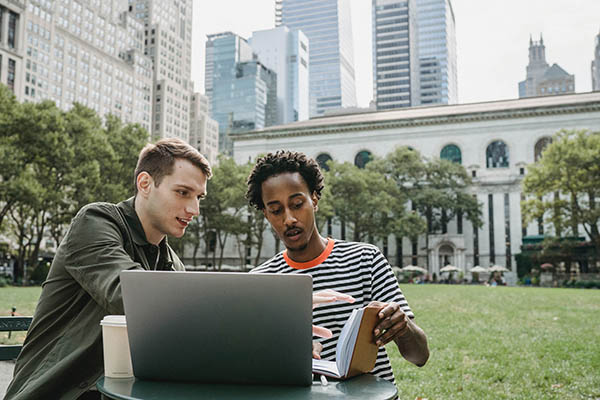 two students studying at a park