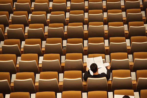 student studying in an empty classroom