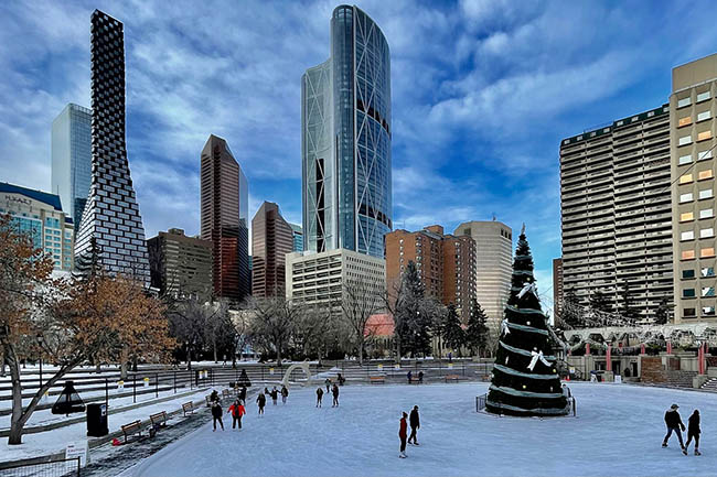 people ice skating at the olympic plaza in calgary