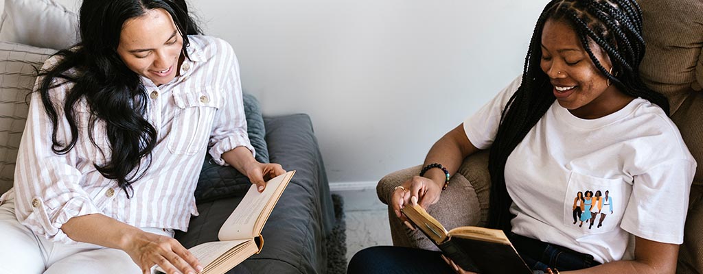 college roommates reading books in their dorm room.