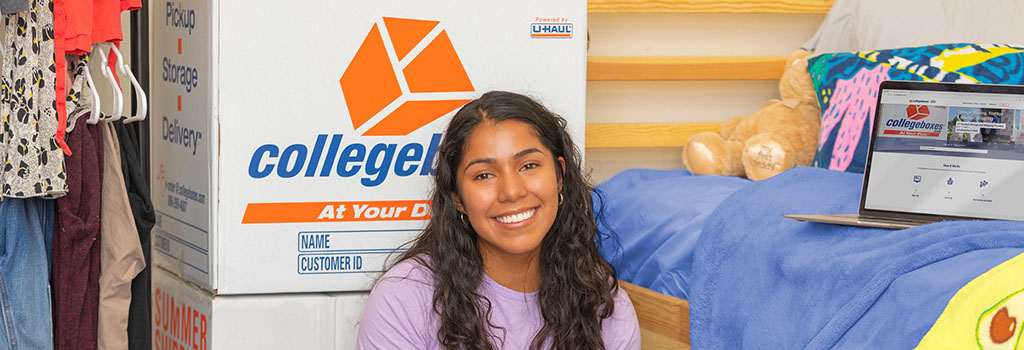 Student smiling in front of Collegeboxes box