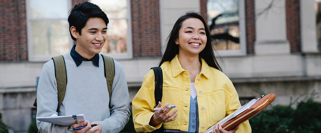 Pair of college students walking around campus