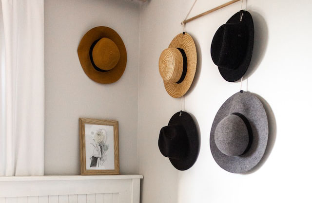 hats hanging on wall