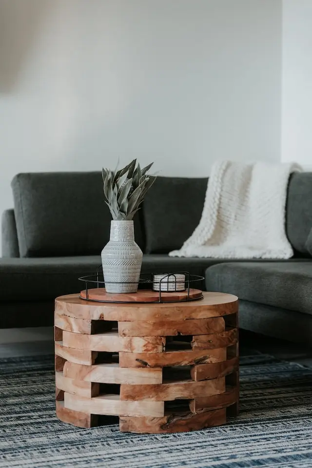 Wooden coffee table standing in front of a couch