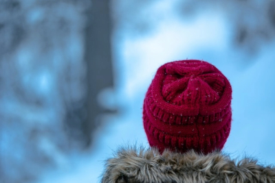 Man with a red beanie in the snow