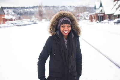 Girl in a black snow coat and a smile