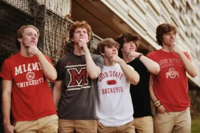 5 boys in college shirts