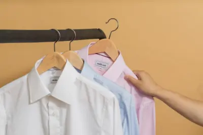 Three collared shirts on a rack