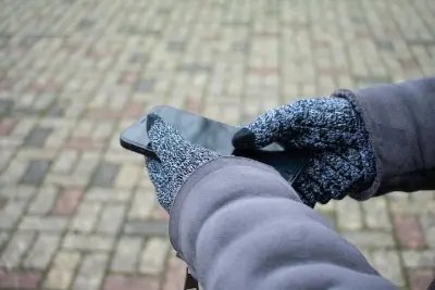 Gloved hands holding a phone