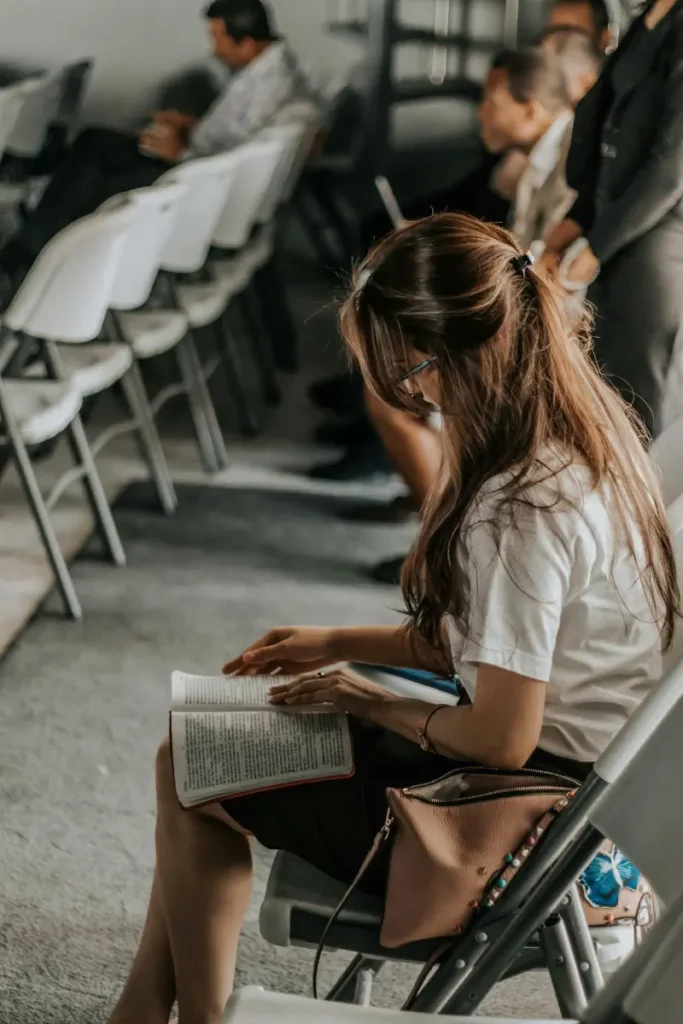 Girl sitting in a chair and reeding some notes