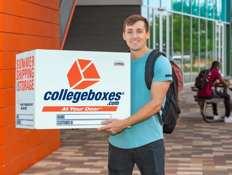Image of a student holding a CollegeBoxes branded box toward the camera