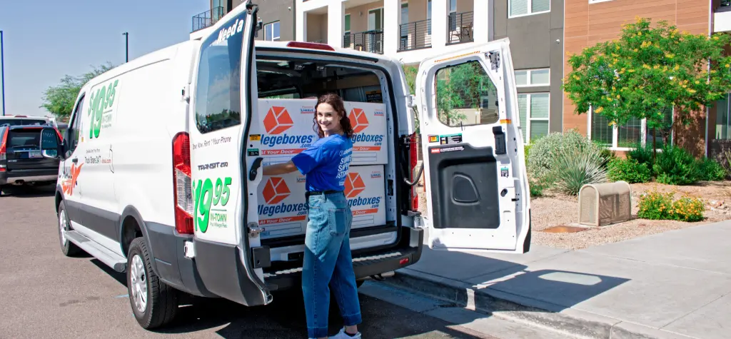 Girl packing up a U-Haul van full of Collegeboxes.